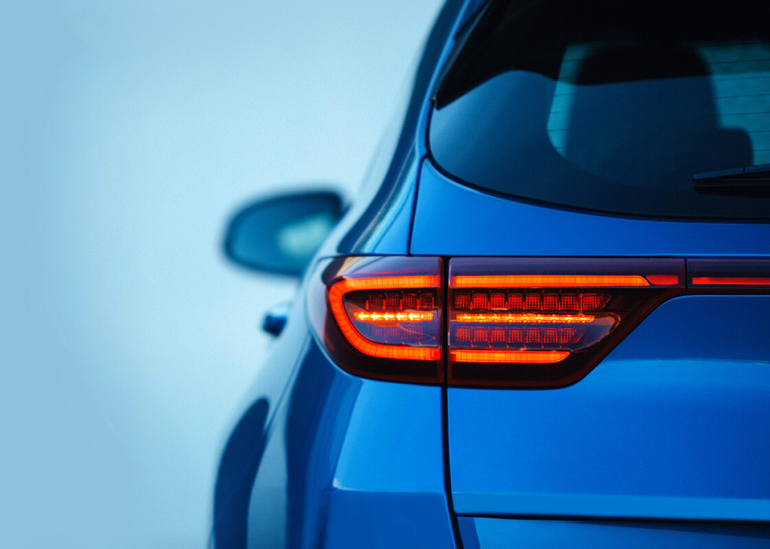 Back of blue car against blue background.