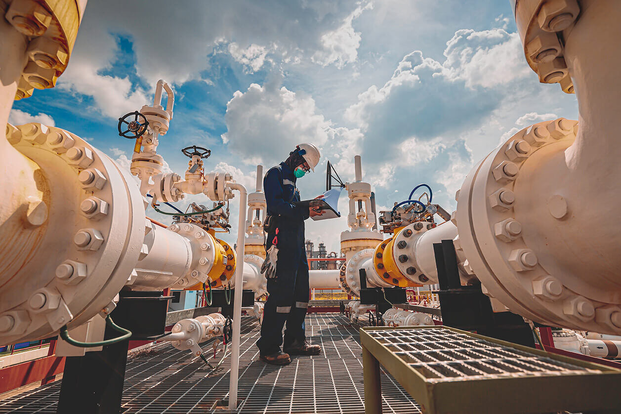 A professional man performing tests amid an industrial setting.